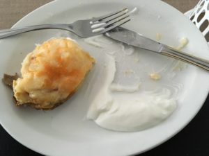 Stuffed Baked Potatoes Served up Hot with a scoop of sour cream